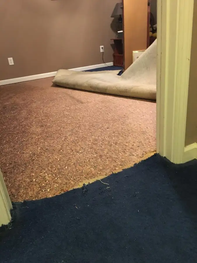 Carpet pad removal revealing water damage during Drying & Dehumidification in Fort Edward